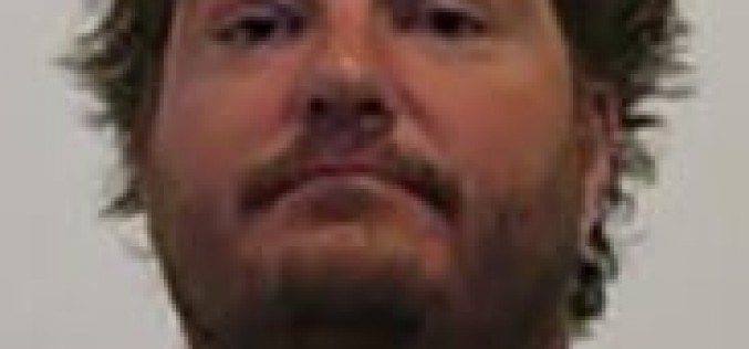 Waving Loaded Gun at Dog Earns Arrest