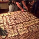 Police display approximately $8,000 apparently seized during their sting