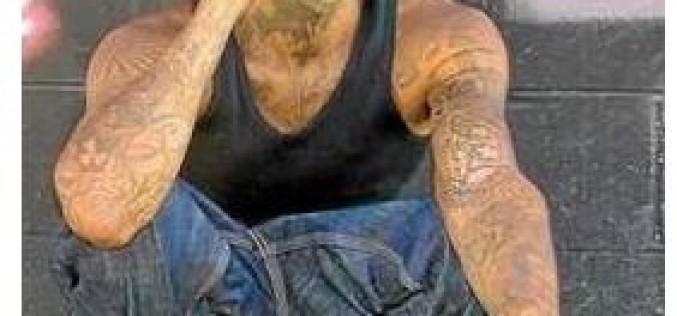 One Arrested, Another Sought in Shooting Death