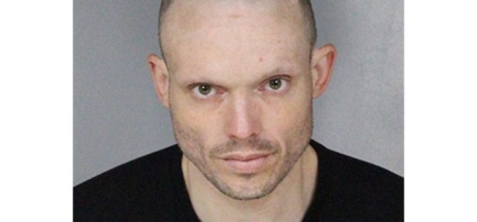 Nodding off in his car with a lot of drugs and two arrest warrants