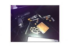 Man drives with drugs, gun, metal knuckles