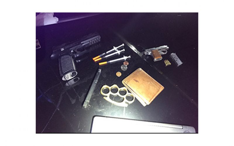 Man drives with drugs, gun, metal knuckles