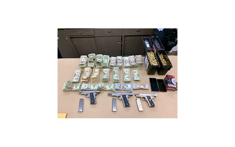 Three guns, drugs and cash seized in search warrant service
