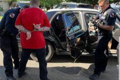 Parolee carries two guns, heroin, parphernalia