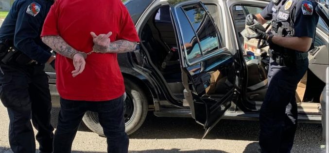 Parolee carries two guns, heroin, parphernalia