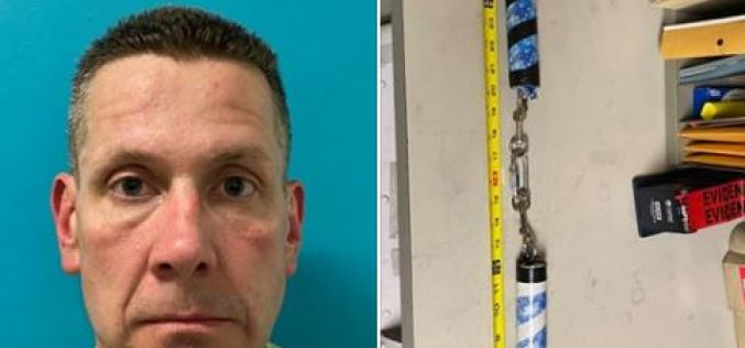 A man at the park, swinging his nunchucks