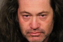 Man sitting in vehicle in parking lot with meth