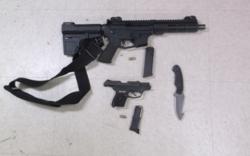 Suspicious man carrying loaded gun, one in his trailer