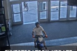 Pair ride through mall on dirt bikes