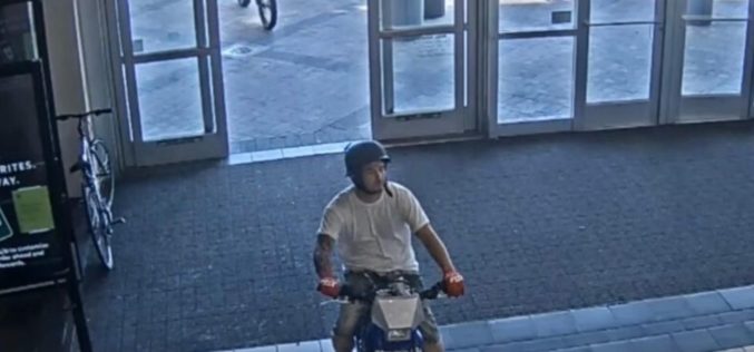 Pair ride through mall on dirt bikes