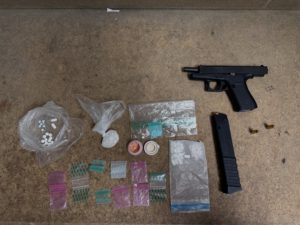 stolen handgun, extended magazine, and narcotics